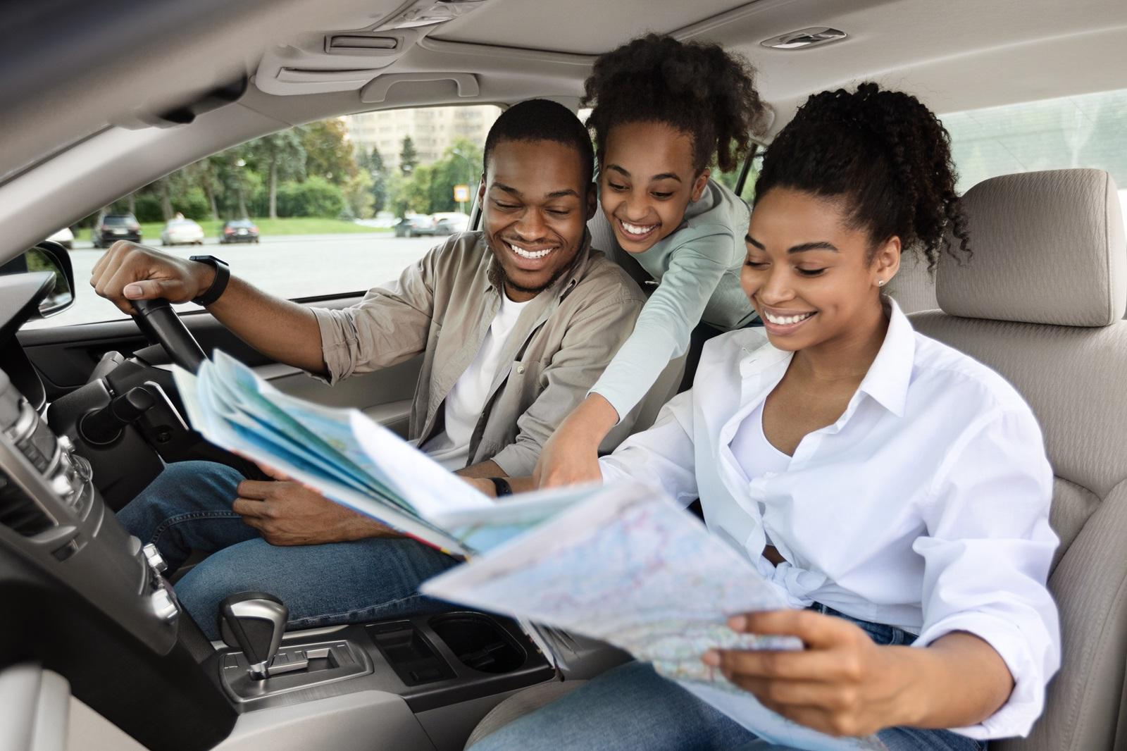 A young family maps out their first road trip in a new vehicle they financed with a consumer loan.